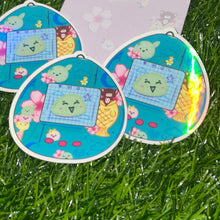 Load image into Gallery viewer, Tamogotchi mochi sticker, holo finish mochi sticker, tamagotchi style sticker, planner sticker, mochi sticker